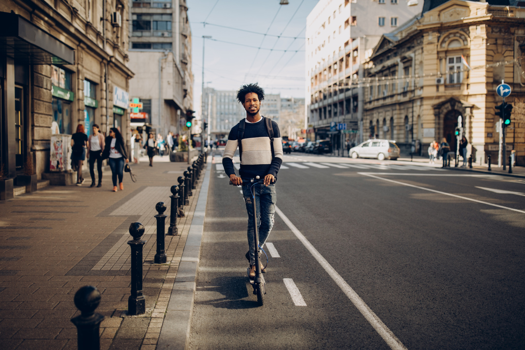 young man riding electric scooter