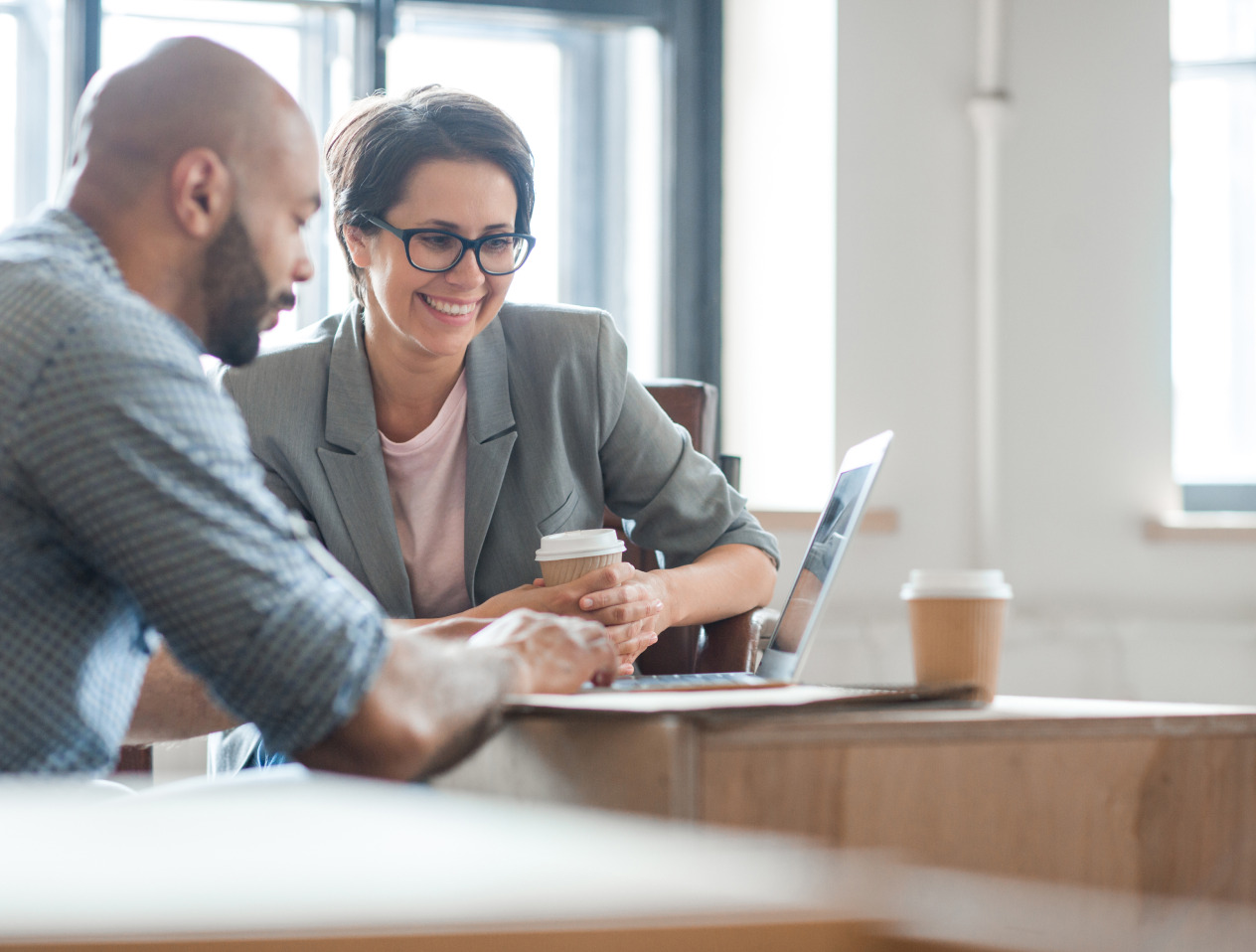 Man and woman working together on a laptop